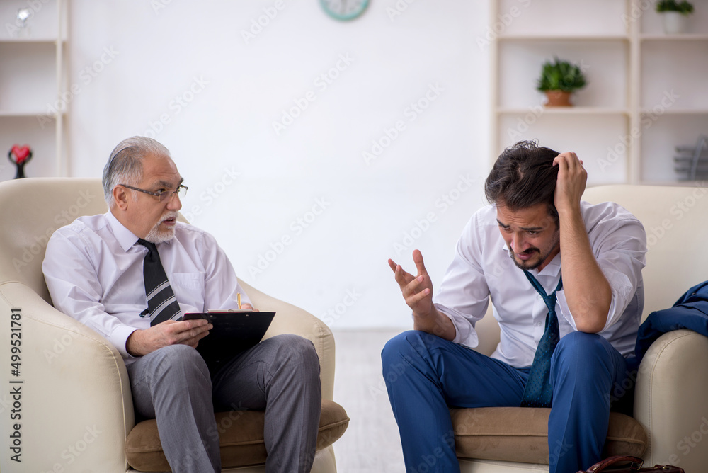 Young businessman employee visiting psychologist Young businessman employee visiting psychologist