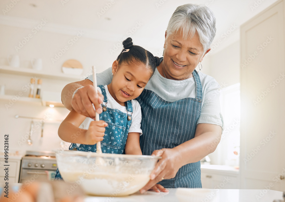 You have to stir it like you mean it. Shot of a little girl baking with her grandmother at home. You have to stir it like you mean it. Shot of a little girl baking with her grandmother at home.