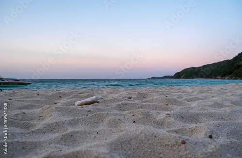 Unclean beach  foam rubbish littered on sand