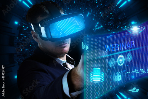 Business, Technology, Internet and network concept. Young businessman working on a virtual screen of the future and sees the inscription: Webinar