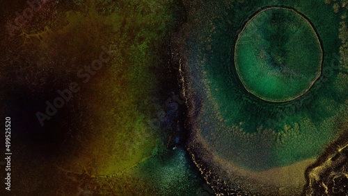 Green and metallic gold liquid ink macro. Abstract explosive light pattern background, Explosion in galaxy cluster. Eye of God, Helix Nebula, Planetary nebula, Big Bang, Outer space, Universe