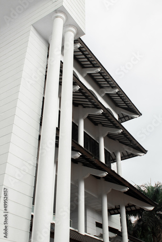 The architecture of the building is white and the roof is brown