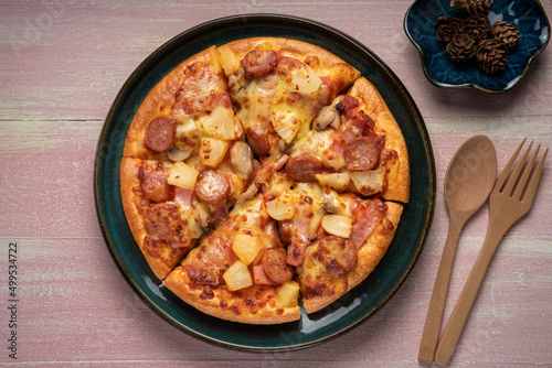 Top view of hot Mushroom and Sausage Pizza on wooden background.