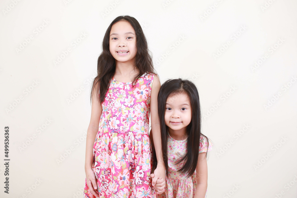 Two happy little girls of joy in full length, isolated on white background Two happy little girls of joy in full length, isolated on white background