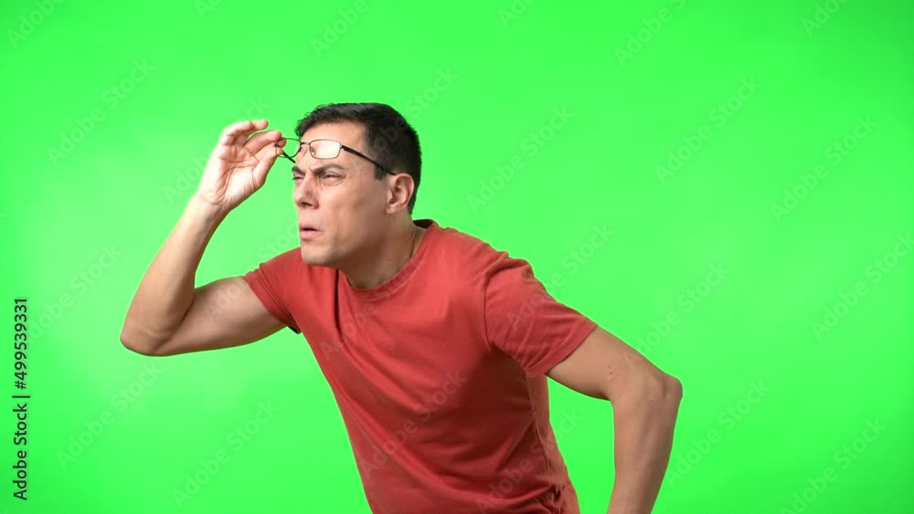Blind male lifting glasses trying to see objects in distance Blind male lifting glasses trying to see objects in distance