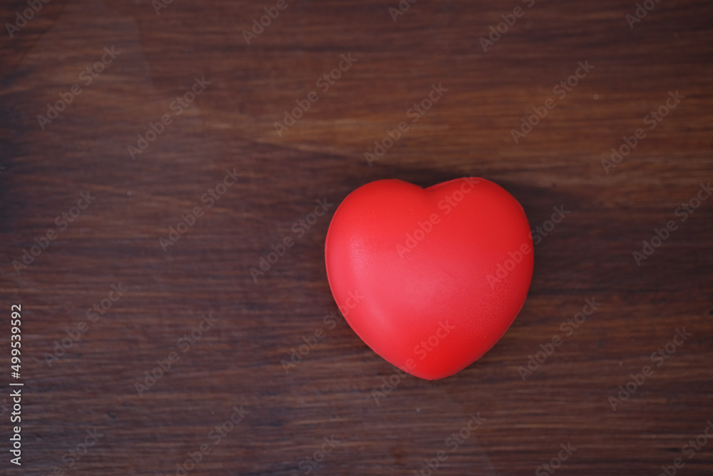 Red heart on wood table. Concept for charity, health insurance, love, international cardiology day. Red heart on wood table. Concept for charity, health insurance, love, international cardiology day.