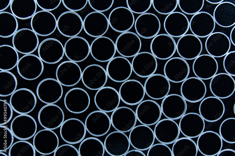 Metal key rings on a black background. Abstract background. Metal key rings on a black background. Abstract background.