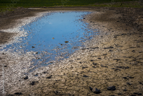 Big muddy puddle in the field in spring