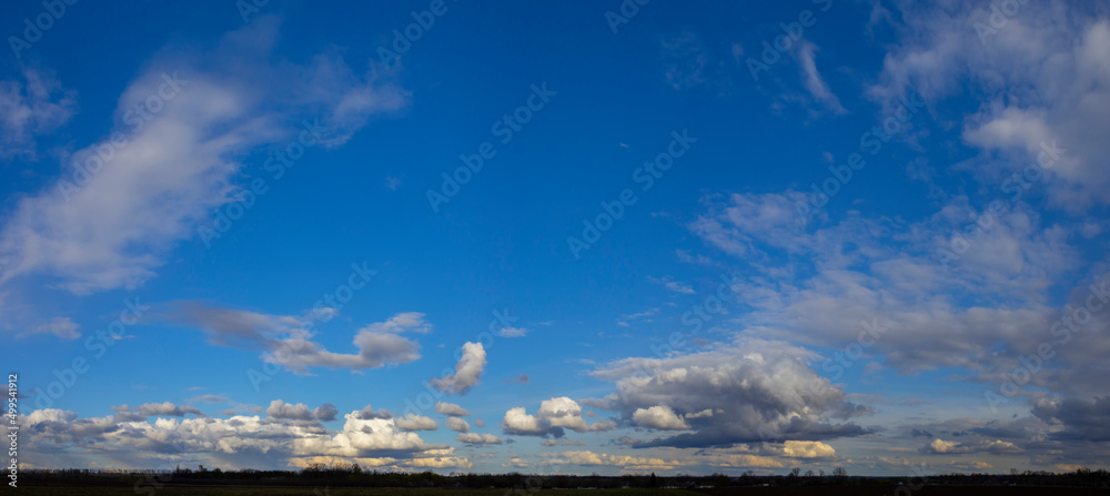 Panorama of blue sky with white fluffy clouds Panorama of blue sky with white fluffy clouds