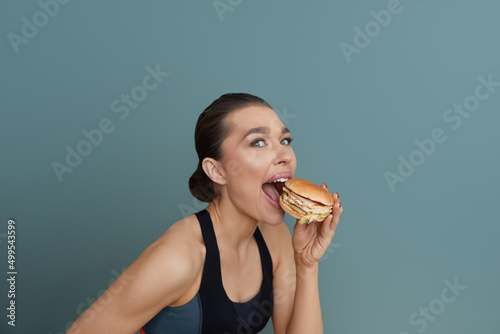 Woman eat a hamburger  a hamburger in her hands  girl with hamburger.