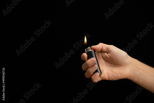 Tela hand of a man handing a lit lighter