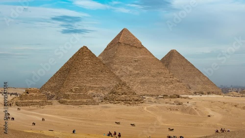 Daily life in Giza complex or necropolis with main pyramids (Great of Giza, of Khafre, of Menkaure), subsidiary ones, remains. Timelapse. Tourists see landmarks of ancient Egypt on horseback, camels photo