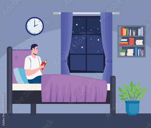 man reading book in bedroom