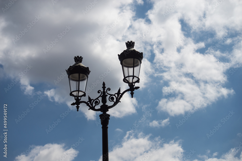 Closeup of vintage street light on beautiful cloudy sky background