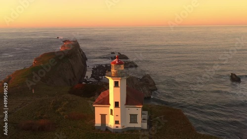 Cape Arago Lighthouse at Gregory Point. Cinematic drone shot of historic landmark at the Oregon Coast. photo