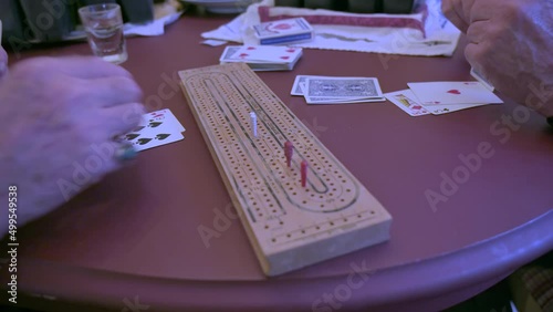 Two friends play cribbage, closeup. Active seniors concept. photo
