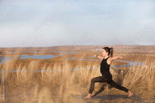 healthy lifestyle. woman practicing yoga and stretching on the mountain in autumn. solo outdoor activities. Social Distancing  © ulza