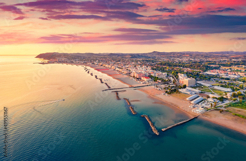 Fototapeta Naklejka Na Ścianę i Meble -  Attractive summer view from flying drone of Cattolica town, Province of Rimini. Captivating sunrise on east coast of Adriatica sea, Italy, Europe. Vacation concept background.