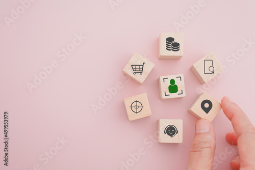 Billede på lærred senior businessman's hand hold check in icon on wooden cube block people inside