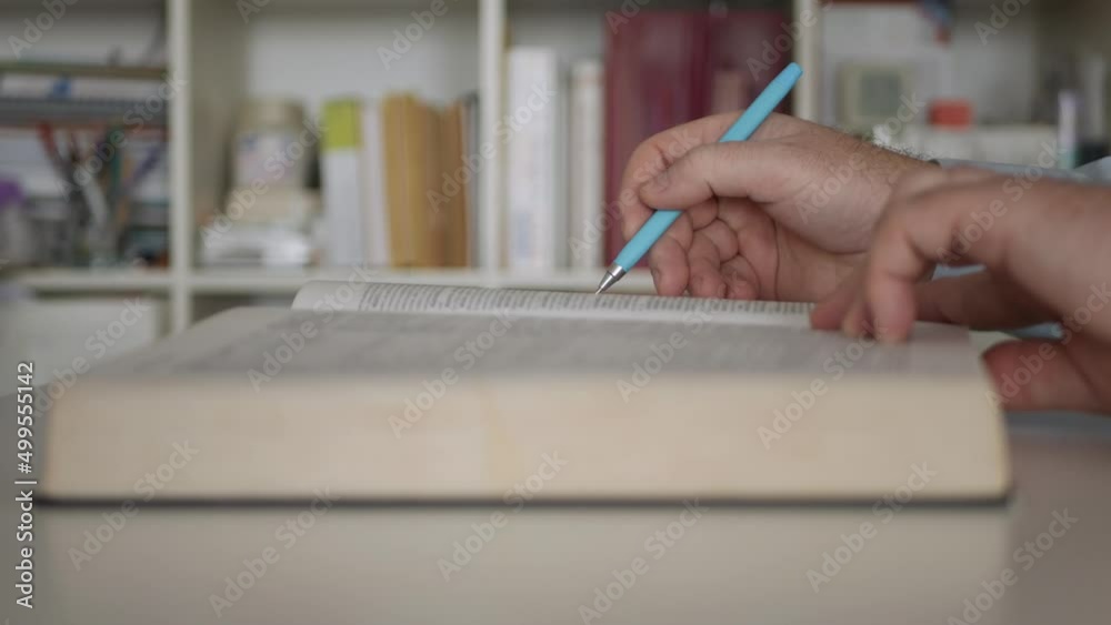 Shooting with a Person in the Office, Reading a Book, and Taking Notes. Man Reading and Learning from a School Book. Shooting with a Person in the Office, Reading a Book, and Taking Notes. Man Reading and Learning from a School Book.