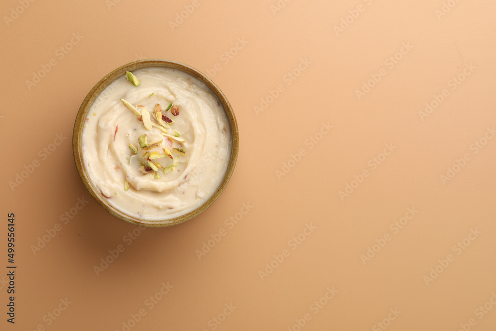 Shrikhand is an Indian sweet dish made of strained curd,garnished with