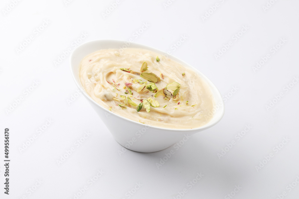 Shrikhand is an Indian sweet dish made of strained curd,garnished with