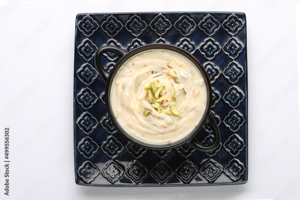 Shrikhand is an Indian sweet dish made of strained curd,garnished with