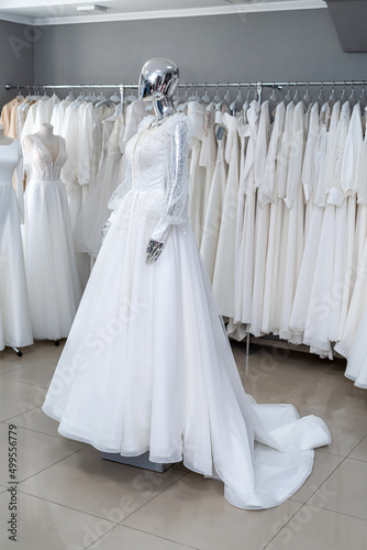 Wedding gowns on display at modern bridal shop showroom