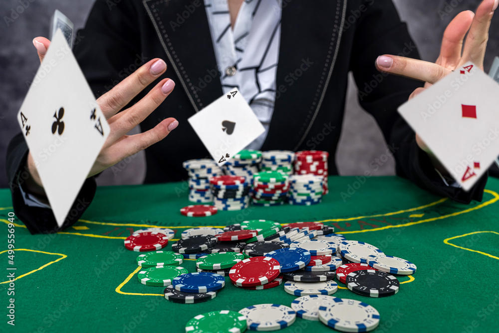 woman wear suit holding chips in casino