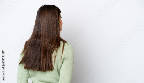 Fotografie Young Brazilian woman isolated on white background in back position and looking