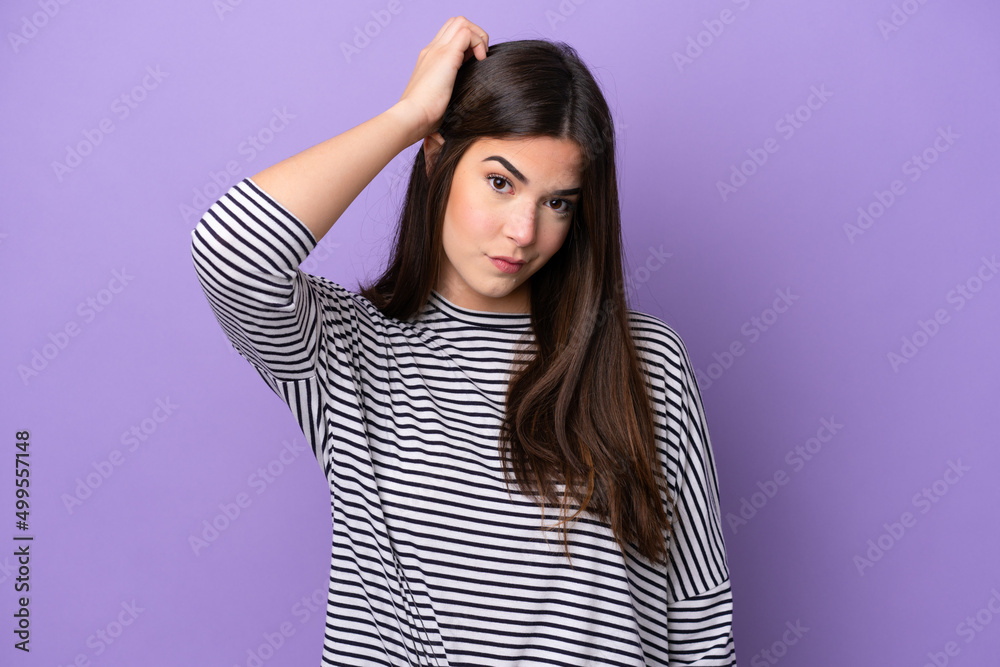 Young Brazilian woman isolated on purple background with an expression of frustration and not understanding Young Brazilian woman isolated on purple background with an expression of frustration and not understanding