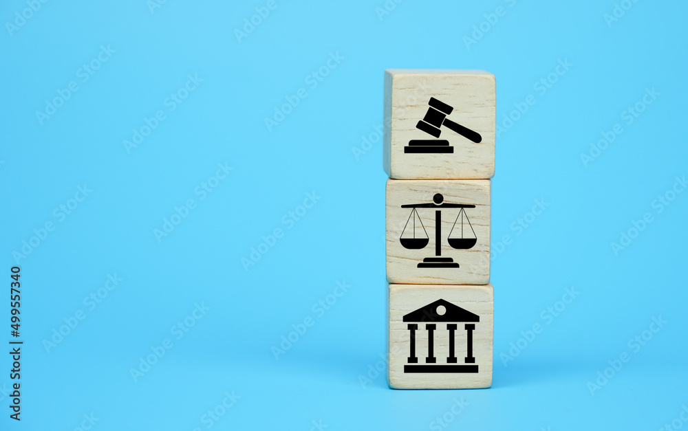Wooden block cube shape with icon law legal justice on a blue background. Wooden block cube shape with icon law legal justice on a blue background.