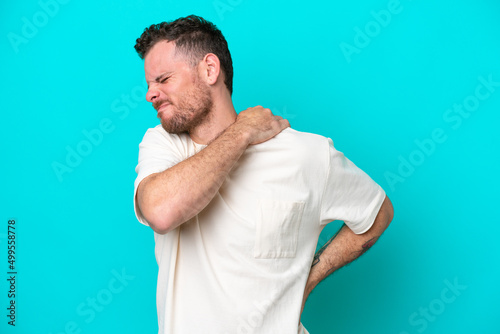 Young Brazilian man isolated on blue background suffering from pain in shoulder for having made an effort