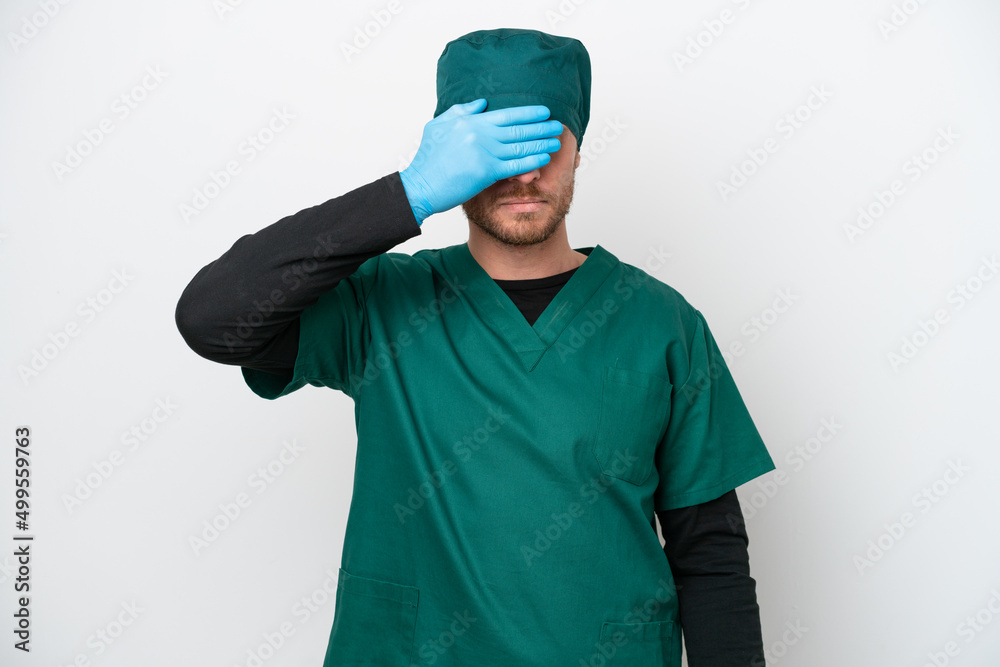 Surgeon Brazilian man in green uniform isolated on white background covering eyes by hands. Do not want to see something