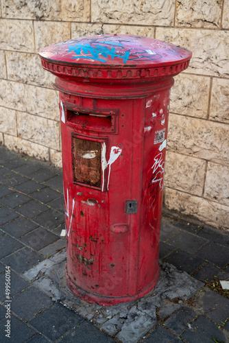 a typical red british mailbox on the street. photo