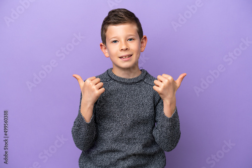 Little boy isolated on purple background with thumbs up gesture and smiling photo