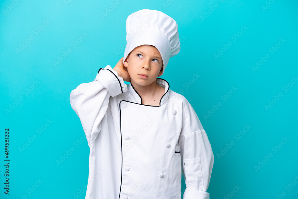 Little chef boy isolated on blue background having doubts Little chef boy isolated on blue background having doubts