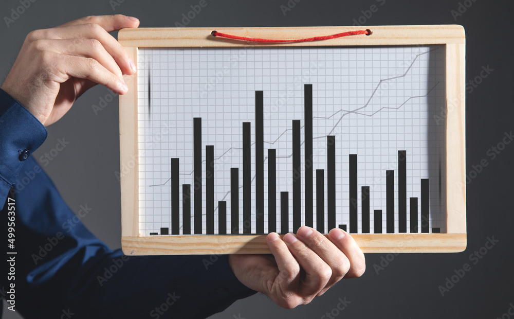 Man showing business graph on whiteboard. Man showing business graph on whiteboard.