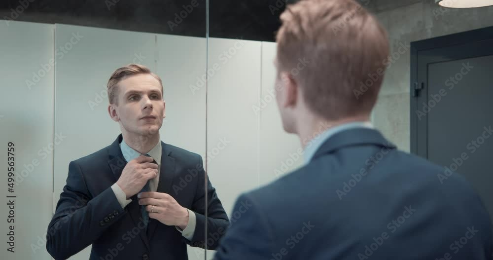 Business man in office bathroom. Stressed manager using restrooms, washroom and lavatories while looking at receding hairline. Male beauty in public toilet with businessman checking hair for loss Business man in office bathroom. Stressed manager using restrooms, washroom and lavatories while looking at receding hairline. Male beauty in public toilet with businessman checking hair for loss