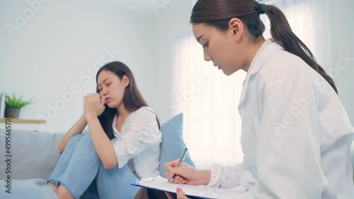 Asian psychology doctor examine and listen to woman patient at home.  photo
