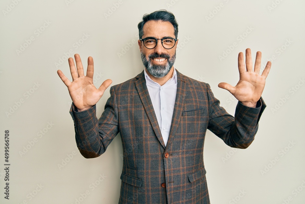 Middle age man with beard and grey hair wearing business jacket and glasses showing and pointing up with fingers number ten while smiling confident and happy.