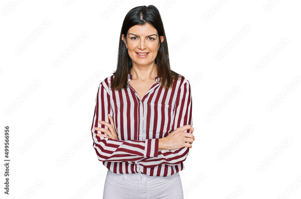 Beautiful brunette woman wearing striped shirt happy face smiling with crossed arms looking at the camera. positive person. Beautiful brunette woman wearing striped shirt happy face smiling with crossed arms looking at the camera. positive person.