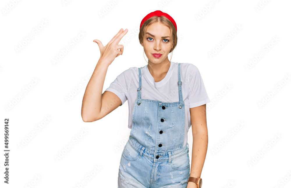 Young caucasian girl wearing casual clothes shooting and killing oneself pointing hand and fingers to head like gun, suicide gesture. Young caucasian girl wearing casual clothes shooting and killing oneself pointing hand and fingers to head like gun, suicide gesture.