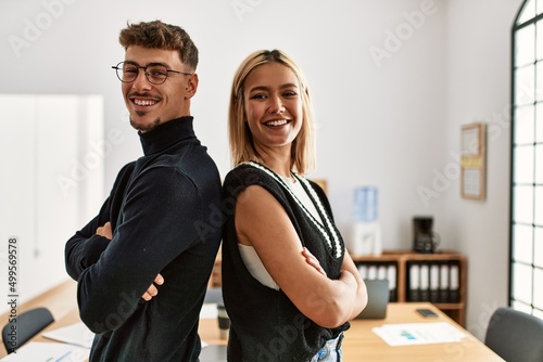 Fototapeta Naklejka Na Ścianę i Meble -  Two business workers smiling happy with arms crossed gesture standing at the office.