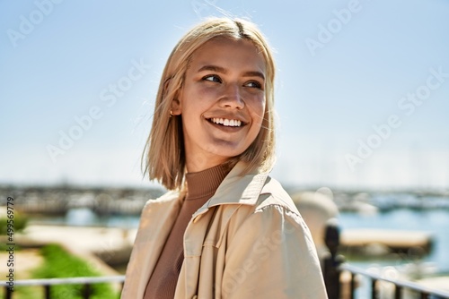 Young blonde girl smiling happy standing at the city. © Krakenimages.com
