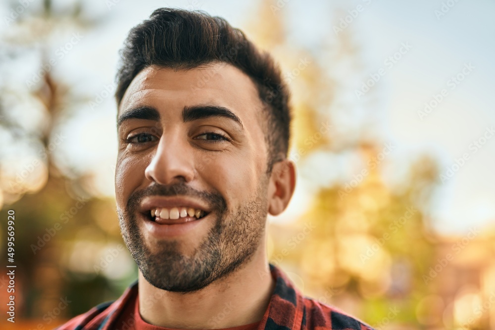 Young hispanic man smiling happy standing at the city. Young hispanic man smiling happy standing at the city.