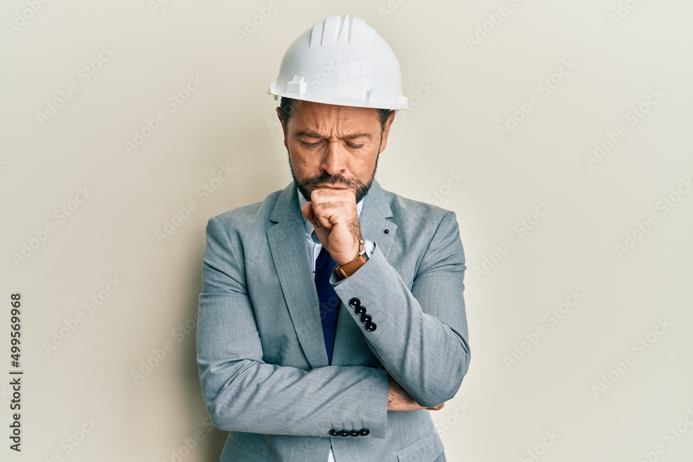 Middle age man wearing architect hardhat feeling unwell and coughing as symptom for cold or bronchitis. health care concept.