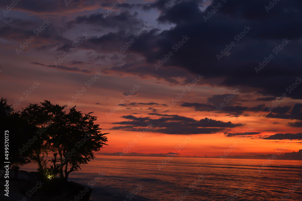 Dramatic sunset sky with clouds. Dramatic sunset over the sea Dramatic sunset sky with clouds. Dramatic sunset over the sea