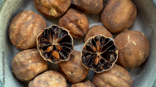 Persian dried whole limes (limu omani) in bowl.