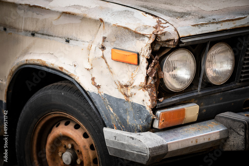 The rusty remains of the car  was in an accident  an abandoned car. Covered with rust  in poor condition